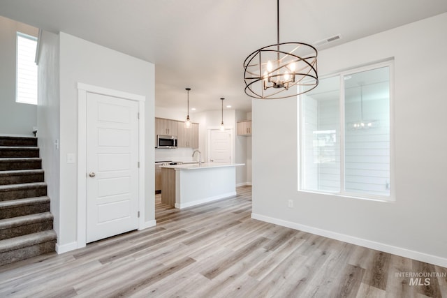 2839 N Rocky Bottom Way, Kuna, ID 83634 - interior space with an inviting chandelier, stairs, baseboards, and light wood-type flooring