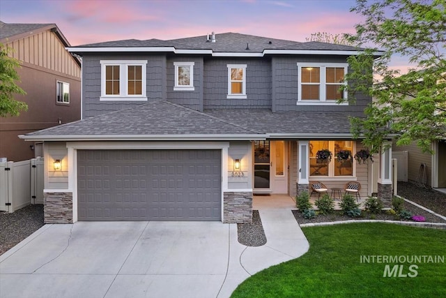 3023 E Tusa St, Meridian, ID 83642 - view of front of house featuring driveway, stone siding, a porch, roof with shingles, and an attached garage