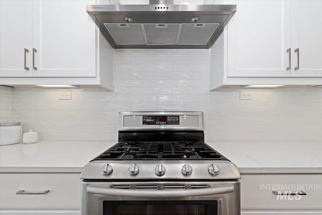3023 E Tusa St, Meridian, ID 83642 - kitchen featuring stainless steel gas range, wall chimney range hood, white cabinets, and tasteful backsplash