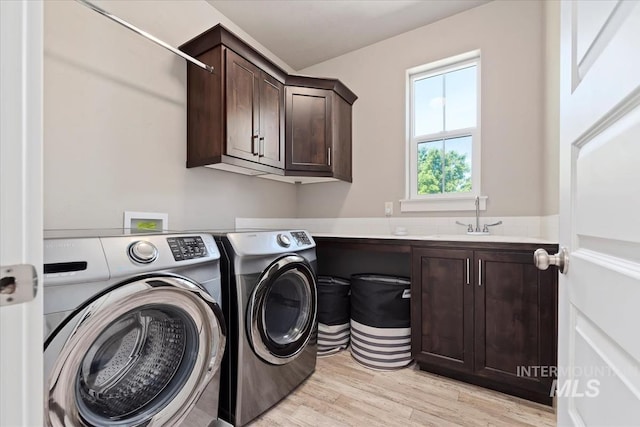 3023 E Tusa St, Meridian, ID 83642 - washroom with washer and clothes dryer, cabinet space, and light wood-style flooring