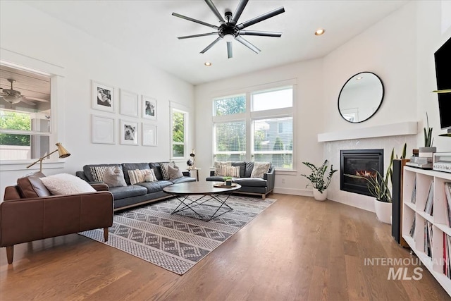 3023 E Tusa St, Meridian, ID 83642 - living room featuring ceiling fan, wood finished floors, a glass covered fireplace, recessed lighting, and baseboards