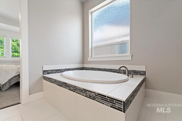 3023 E Tusa St, Meridian, ID 83642 - ensuite bathroom with a garden tub and tile patterned floors