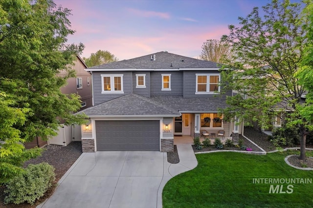 3023 E Tusa St, Meridian, ID 83642 - view of front of house featuring a shingled roof, concrete driveway, a garage, covered porch, and stone siding