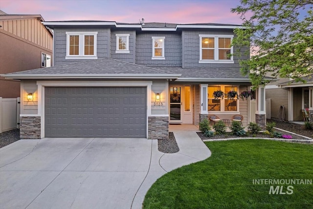 3023 E Tusa St, Meridian, ID 83642 - view of front of house with stone siding, concrete driveway, a front yard, and an attached garage