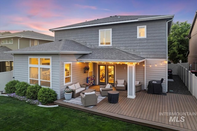 3023 E Tusa St, Meridian, ID 83642 - back of property at dusk featuring an outdoor hangout area, a deck, and roof with shingles