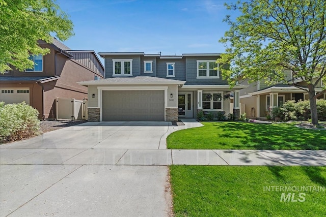 3023 E Tusa St, Meridian, ID 83642 - view of front of home with driveway, stone siding, a front lawn, and a garage