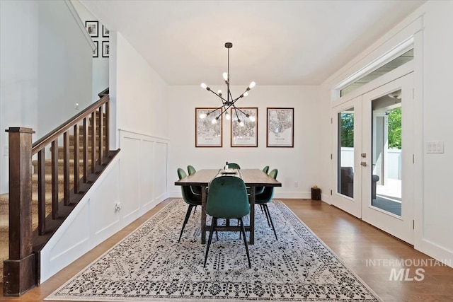 3023 E Tusa St, Meridian, ID 83642 - dining room with french doors, a chandelier, stairs, and wood finished floors