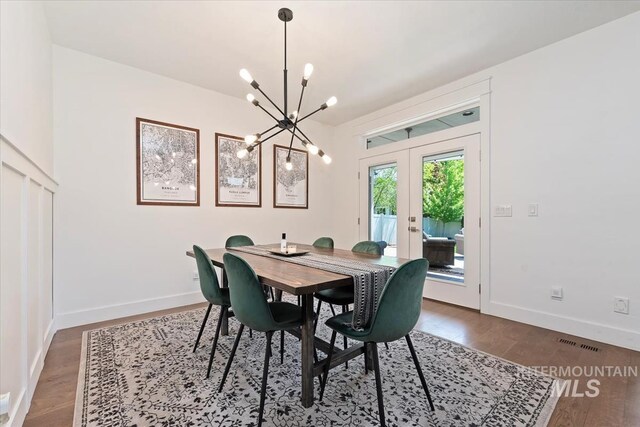 3023 E Tusa St, Meridian, ID 83642 - dining room with a chandelier, french doors, wood finished floors, and baseboards