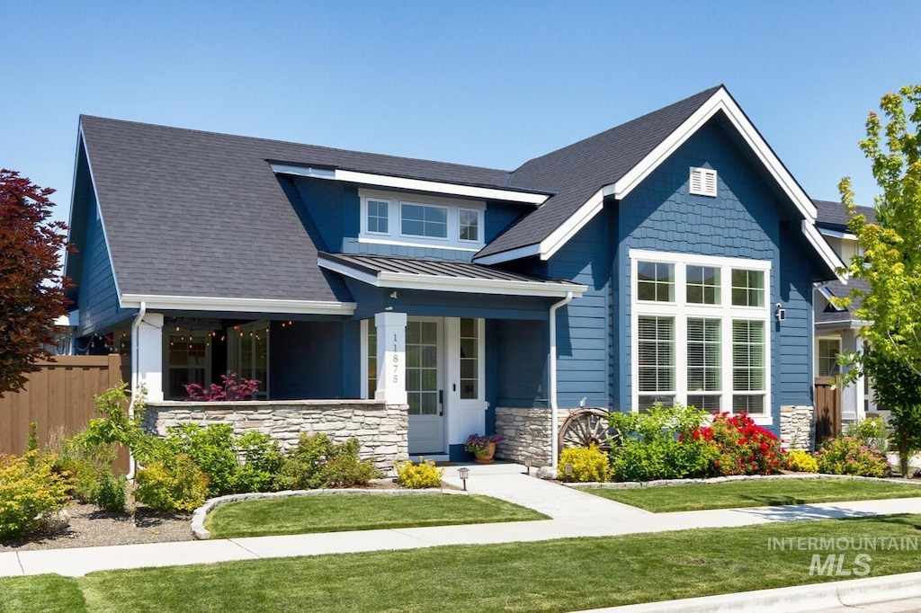 11875 N 21st Ave, Boise, ID 83714 - craftsman inspired home with a standing seam roof, stone siding, metal roof, covered porch, and a shingled roof