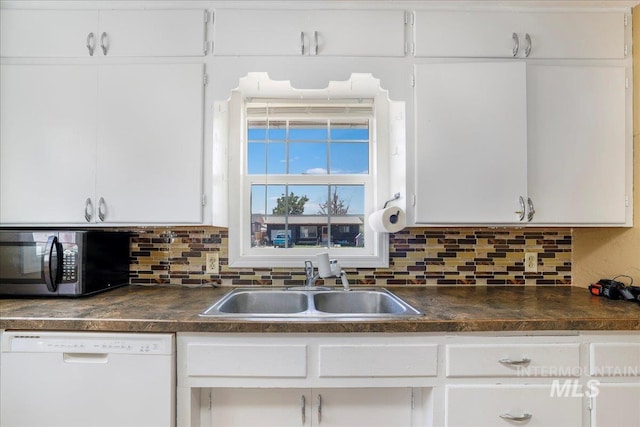 904 N 9th Ave, Buhl, ID 83316 - kitchen with dishwasher, a sink, stainless steel microwave, dark countertops, and backsplash