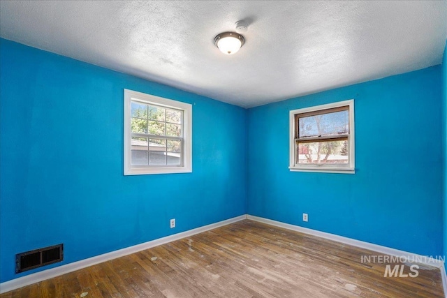 904 N 9th Ave, Buhl, ID 83316 - spare room with wood finished floors, baseboards, a textured ceiling, and a smoke detector