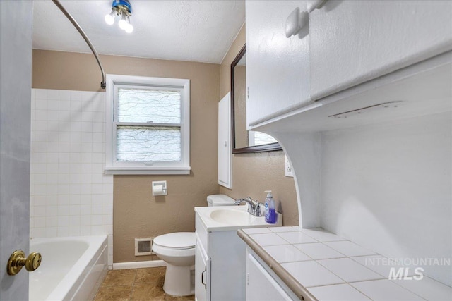 904 N 9th Ave, Buhl, ID 83316 - full bath featuring vanity, toilet, tile patterned floors, baseboards, and shower / washtub combination
