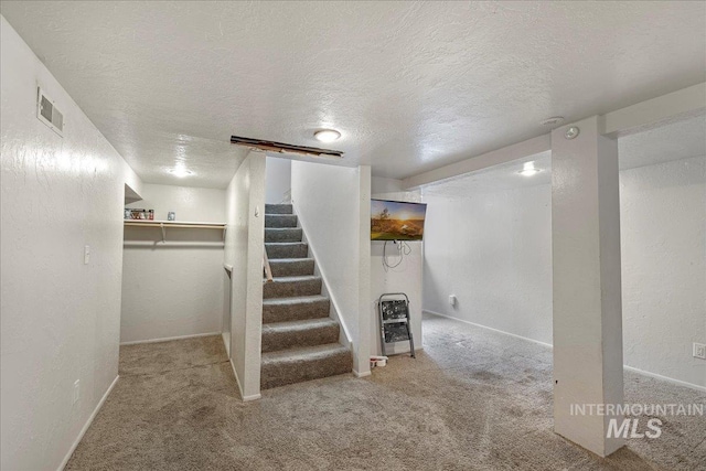 904 N 9th Ave, Buhl, ID 83316 - finished basement with carpet floors, a textured ceiling, heating unit, stairs, and baseboards