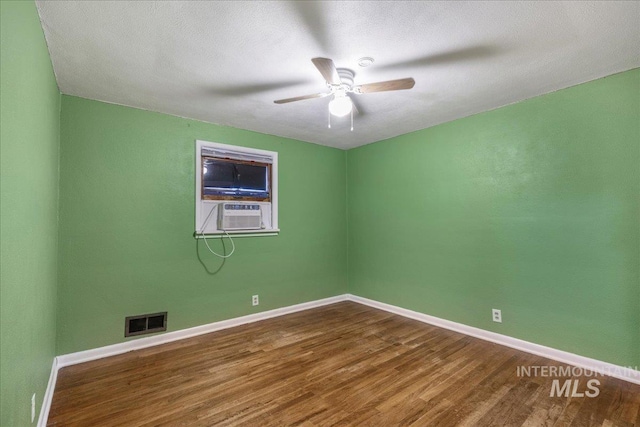 904 N 9th Ave, Buhl, ID 83316 - empty room featuring wood finished floors, ceiling fan, baseboards, and cooling unit