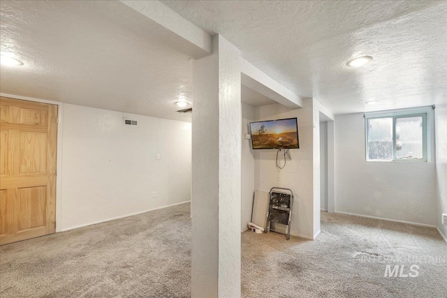 904 N 9th Ave, Buhl, ID 83316 - below grade area with a textured ceiling, carpet, heating unit, and baseboards