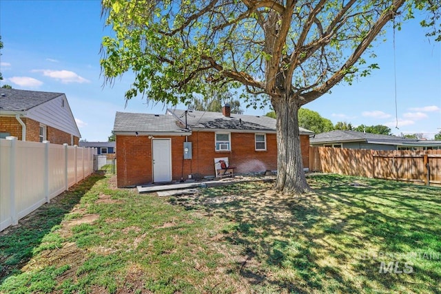 904 N 9th Ave, Buhl, ID 83316 - rear view of house featuring brick siding and a chimney