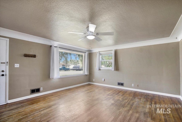 904 N 9th Ave, Buhl, ID 83316 - unfurnished room featuring wood finished floors, ceiling fan, baseboards, and a textured ceiling