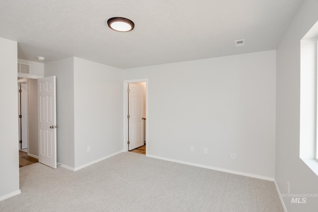 unfurnished bedroom featuring light colored carpet