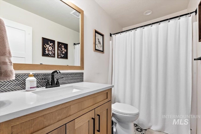 bathroom with visible vents, toilet, and vanity