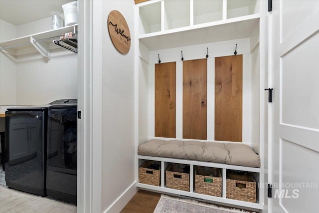 mudroom with wood finished floors, baseboards, and washing machine and clothes dryer