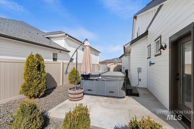 view of patio with a hot tub and a fenced backyard