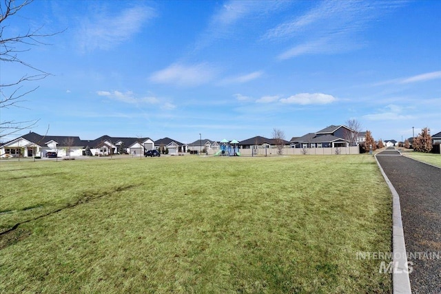 view of yard with a residential view and fence