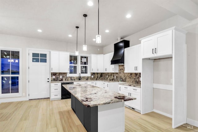 kitchen with light hardwood / wood-style flooring, a center island, pendant lighting, custom exhaust hood, and white cabinets