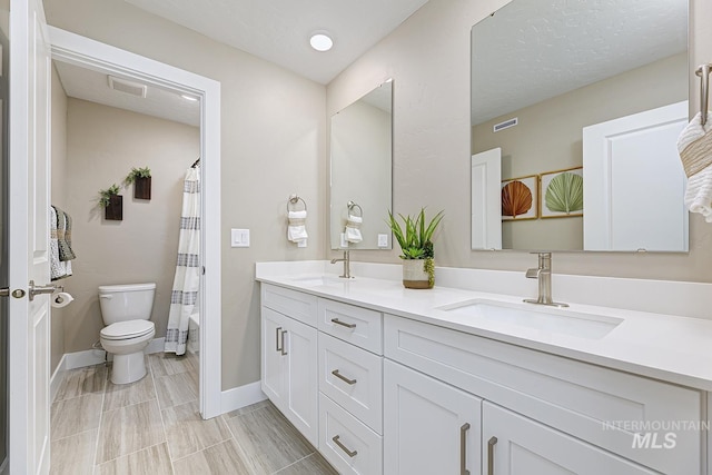 8002 W Fern St, Eagle, ID 83616 - bathroom featuring double vanity, toilet, and baseboards