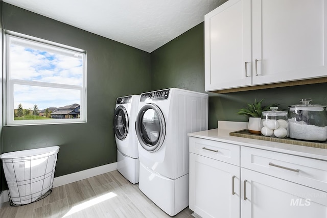 8002 W Fern St, Eagle, ID 83616 - washroom featuring washing machine and clothes dryer, cabinet space, and baseboards