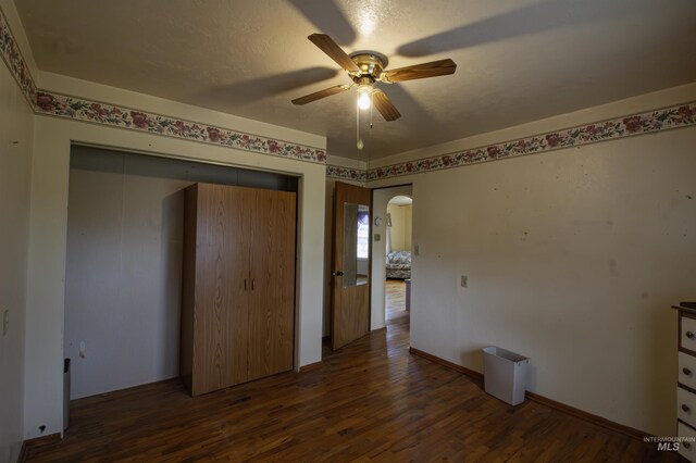 8970 Hurd Ln With 7, Acres, Payette, ID 83661 - unfurnished bedroom with arched walkways, wood finished floors, a closet, and ceiling fan
