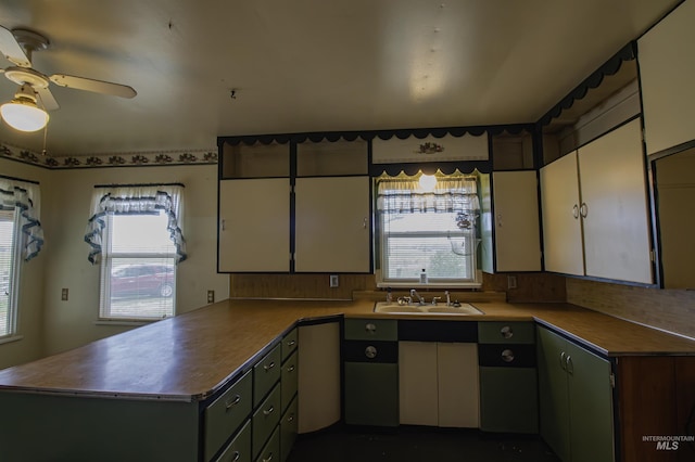8970 Hurd Ln With 7, Acres, Payette, ID 83661 - kitchen featuring a sink, a peninsula, white cabinets, a ceiling fan, and backsplash