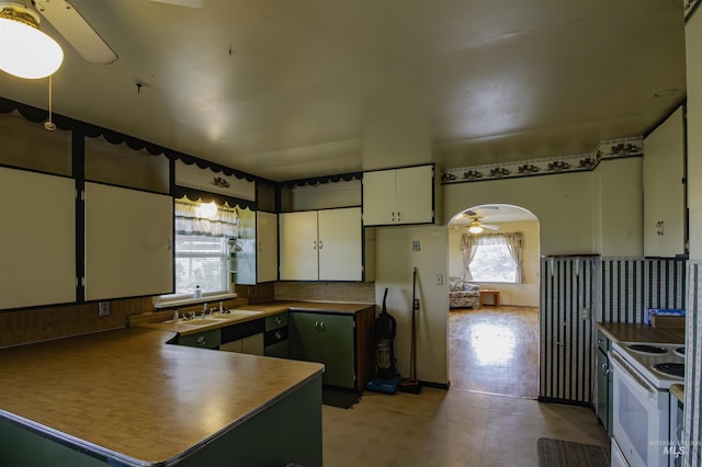 8970 Hurd Ln With 7, Acres, Payette, ID 83661 - kitchen featuring a ceiling fan, a sink, a peninsula, white electric range oven, and white cabinets
