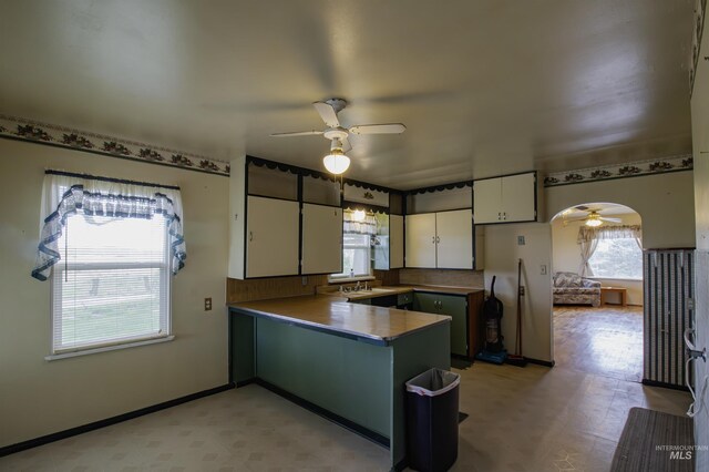 8970 Hurd Ln With 7, Acres, Payette, ID 83661 - kitchen with ceiling fan, a peninsula, freestanding refrigerator, white cabinetry, and a sink