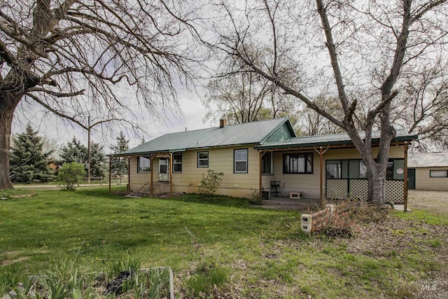 8970 Hurd Ln With 7, Acres, Payette, ID 83661 - rear view of house with metal roof, a yard, and a chimney