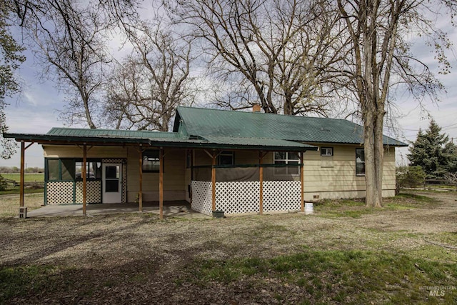 8970 Hurd Ln With 7, Acres, Payette, ID 83661 - back of house featuring metal roof, a chimney, and crawl space