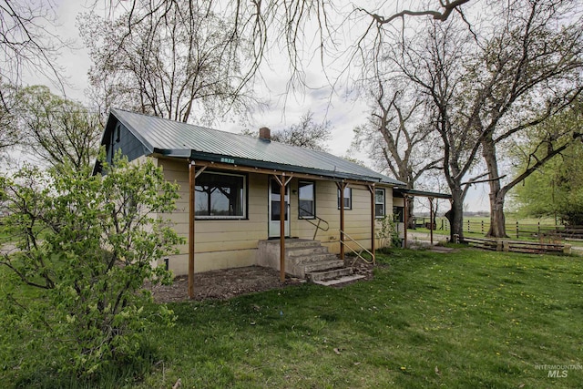 8970 Hurd Ln With 7, Acres, Payette, ID 83661 - view of front of home featuring metal roof, a front lawn, and a chimney