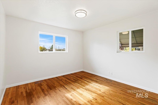 unfurnished room featuring wood-type flooring