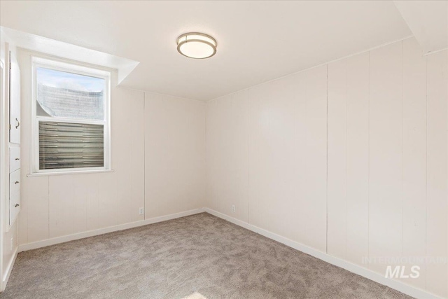 unfurnished room featuring light colored carpet