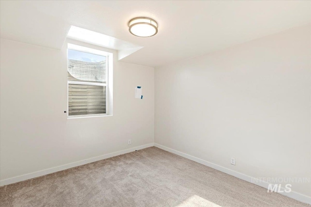 unfurnished room with light carpet