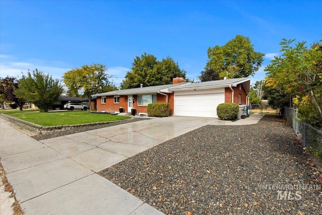 single story home with a front yard and a garage