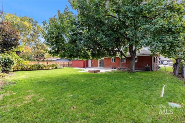 view of yard with a patio area and central AC unit