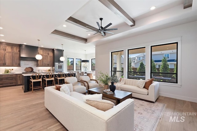 living room featuring recessed lighting, beam ceiling, light wood-type flooring, a ceiling fan, and baseboards