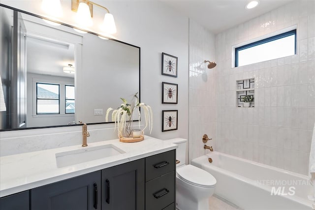 full bathroom featuring toilet, vanity, and  shower combination