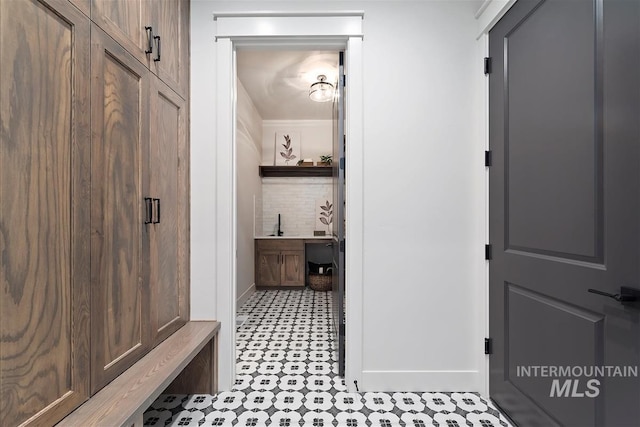 bathroom with decorative backsplash and baseboards