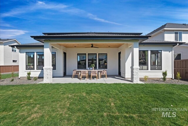 back of house featuring a sunroom, a ceiling fan, stucco siding, and a patio area
