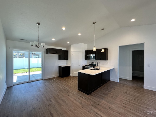 TBD Idaho, Caldwell, ID 83605 - kitchen with stainless steel appliances, a chandelier, vaulted ceiling, a peninsula, and dark wood finished floors