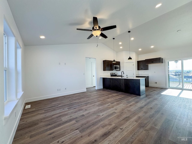 TBD Idaho, Caldwell, ID 83605 - kitchen featuring stainless steel microwave, open floor plan, vaulted ceiling, ceiling fan, and dark brown cabinetry