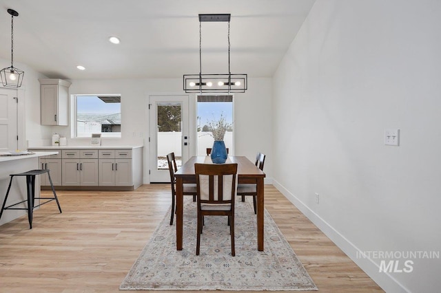 dining area with light wood-type flooring, baseboards, and recessed lighting