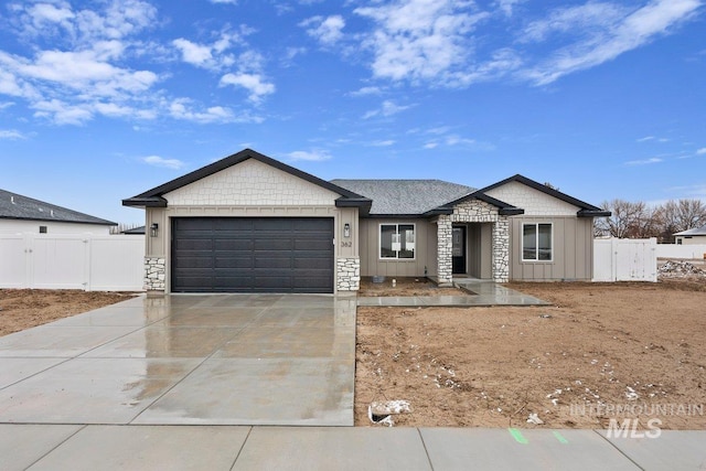 view of front of property featuring a garage, driveway, fence, and board and batten siding