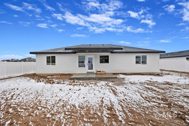 snow covered house featuring crawl space, a fenced backyard, and a patio